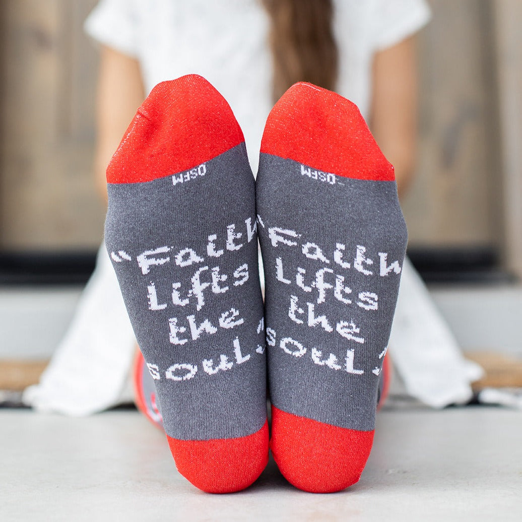 a pair of red and gray socks with words written on them