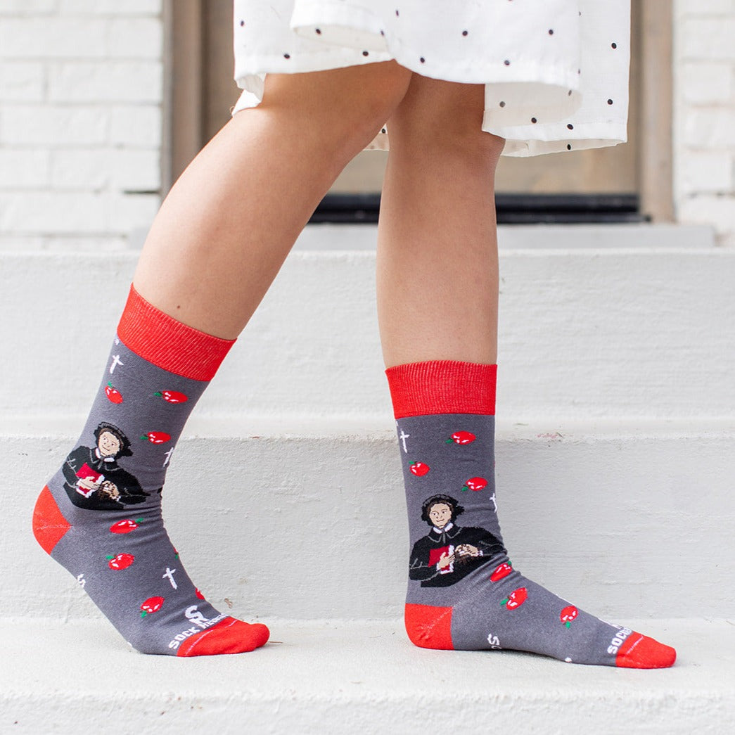 a person wearing a pair of socks with a picture of St. Elizabeth Ann Seton