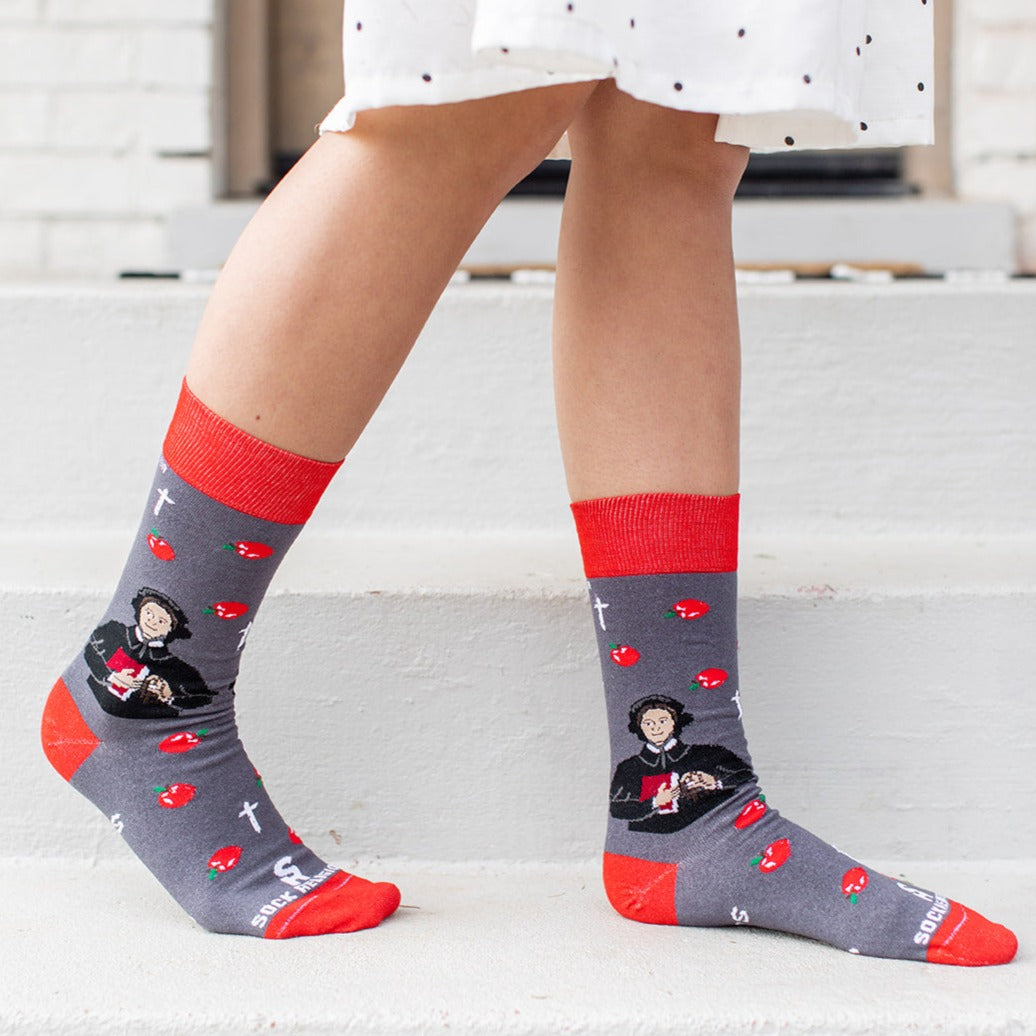 a woman's legs wearing a pair of socks with a picture of St. Elizabeth Ann Seton
