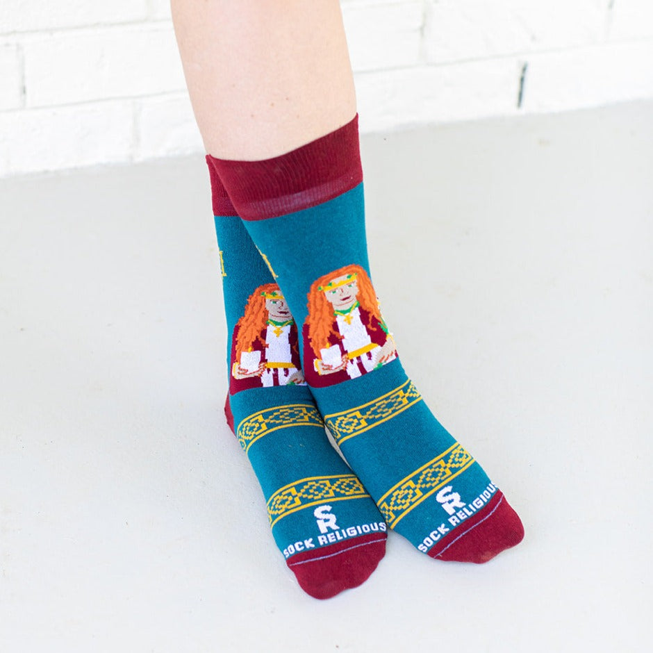 a person wearing a pair of socks with a picture of St. Dymphna