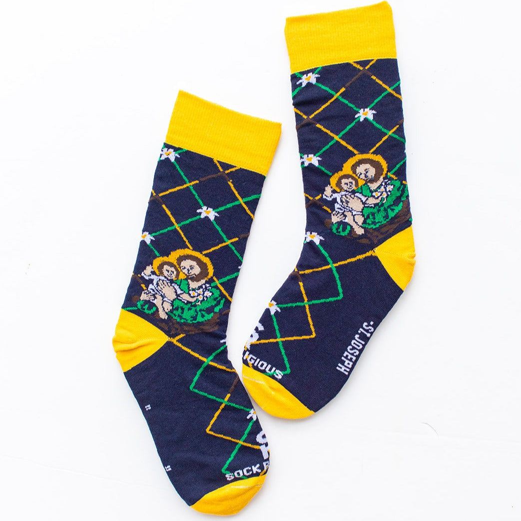 Navy blue St. Joseph adult XL socks with Joseph holding baby Jesus. Yellow and green argyle lines flat lay image