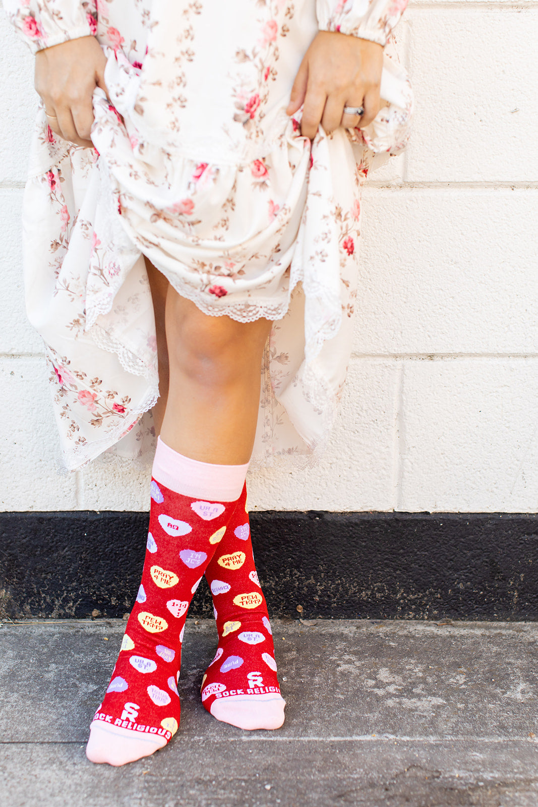 a woman wearing red socks with hearts on them