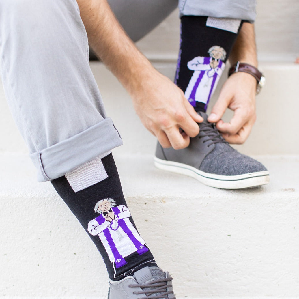 a man tying his shoes with a socks
