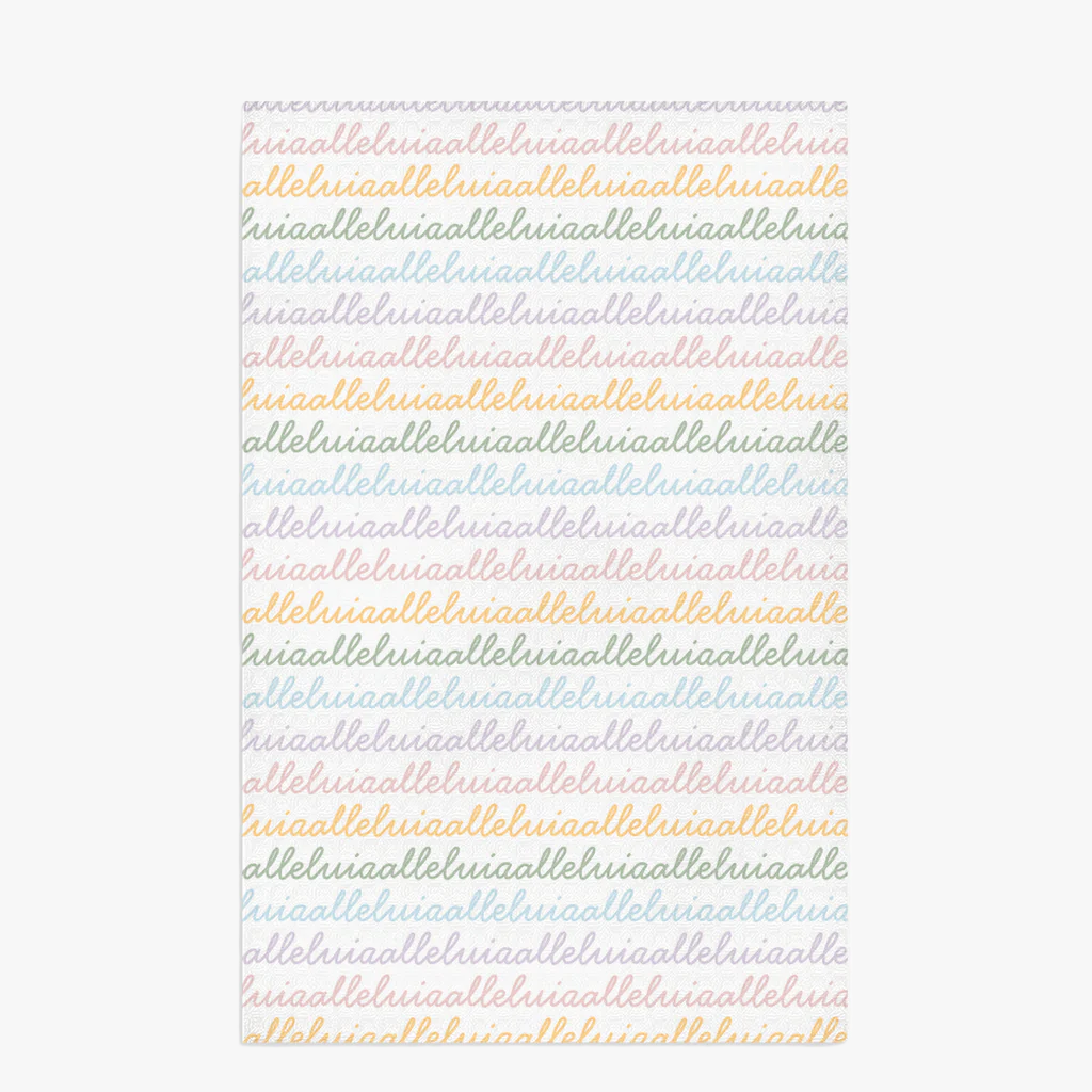 White colored, waffle textured dish towel laid flat with the design that says alleluia, alleluia repeatedly in cursive writing, in colors pastel pink, pastel yellow, pastel blue and pastel green.