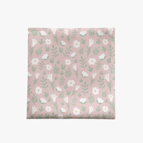 Light pink Easter Alleluia napkin with simple white floral design, shown on a white background.