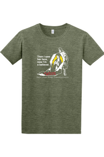 military green t-shirt with St. Juan Diego wearing tilma that shows Our Lady of Guadalupe. Shirt says "Then I saw her face, now I'm a believer"