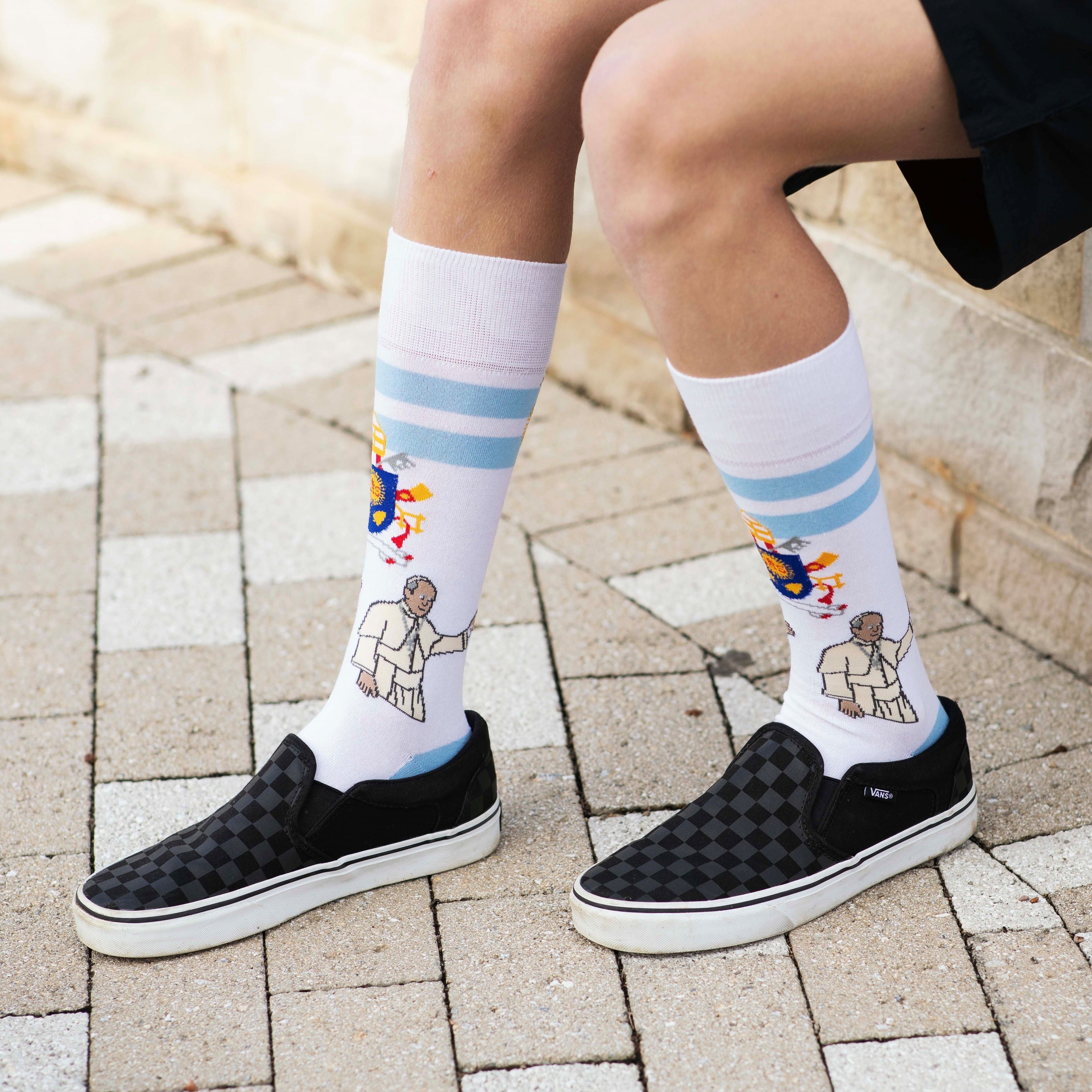 a person wearing a pair of socks with a picture of Pope Francis