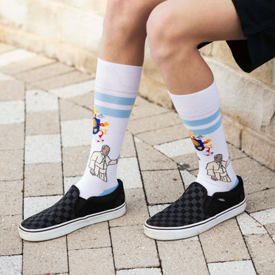 a person wearing a pair of socks with a picture of Pope Francis