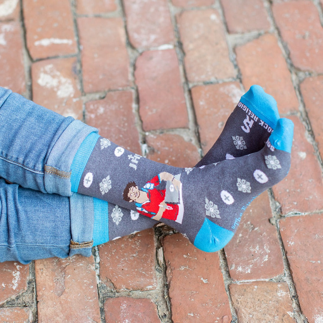 a person wearing a pair of socks with mickey mouse on them