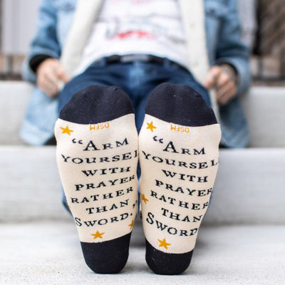 a person sitting on a step wearing socks with words written on them
