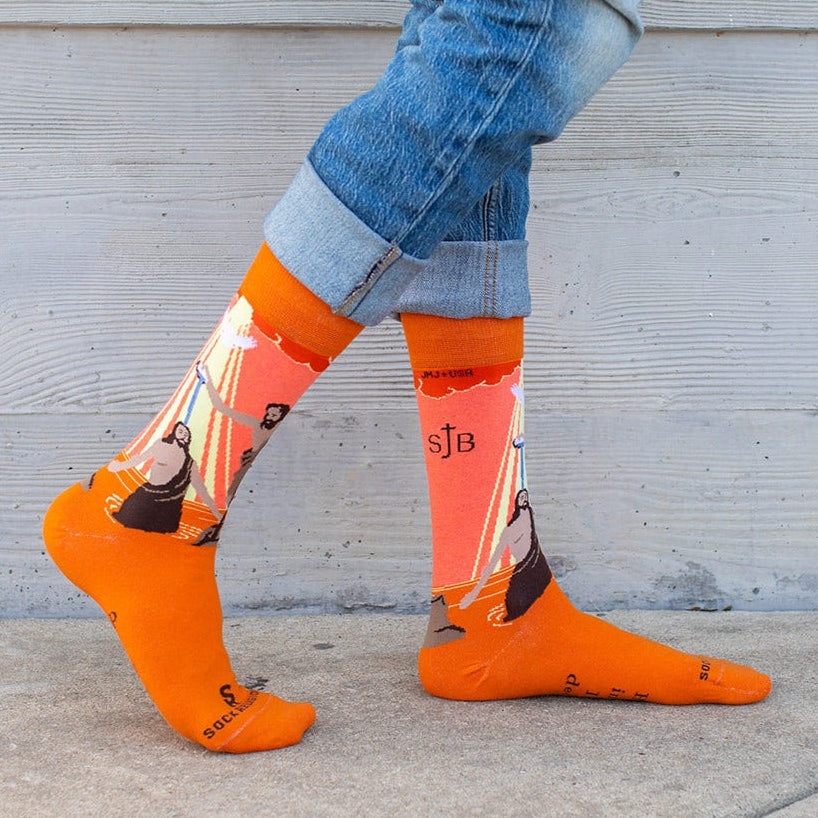 a person wearing orange socks and blue jeans