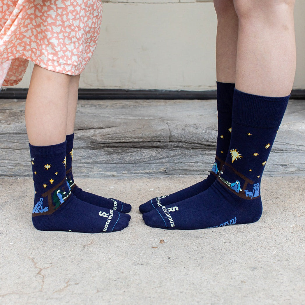 mother and child standing wearing matching nativity dress socks