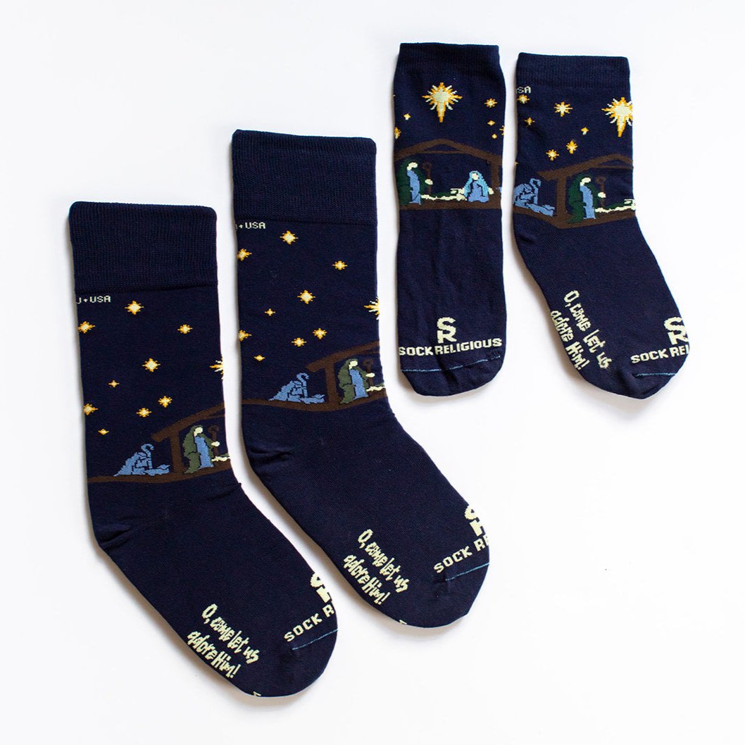 adult and kids dark navy blue socks featuring simple silhouettes of the manger scene