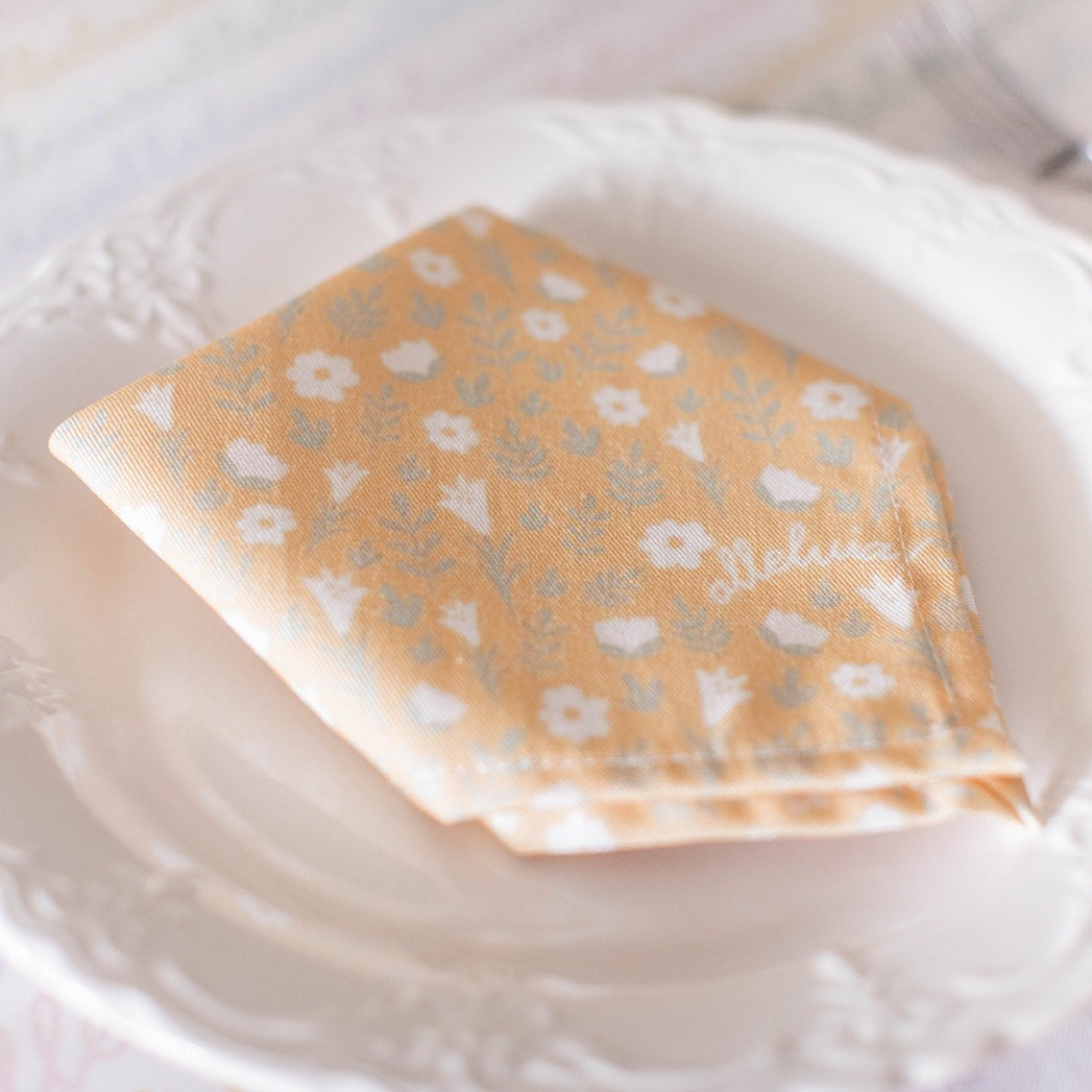 light yellow colored napkin placed on a table setting 