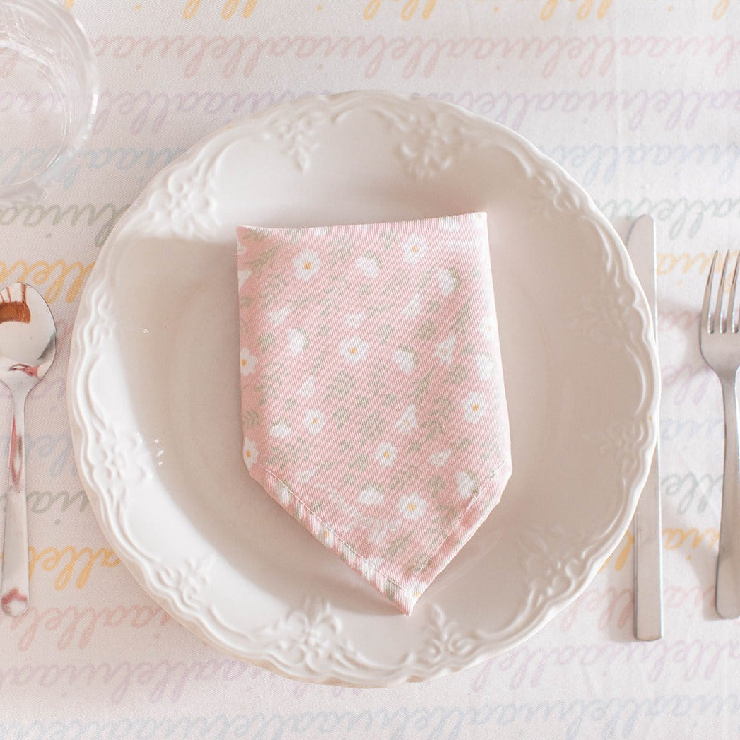 light pink colored napkin placed on a table setting 