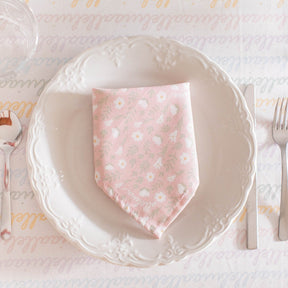 light pink colored napkin placed on a table setting 