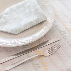 light blue colored napkin placed on a table setting 