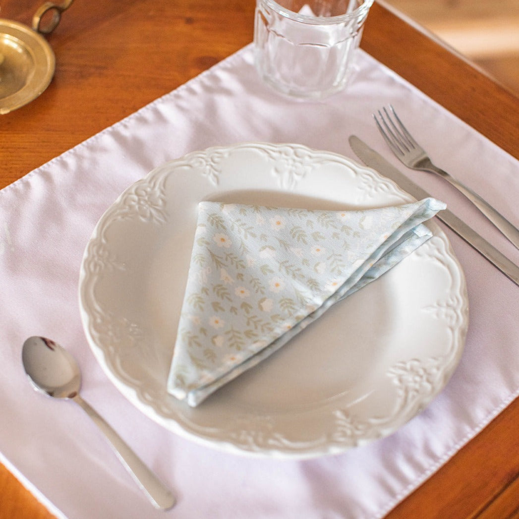 light blue colored napkin placed on a table setting 