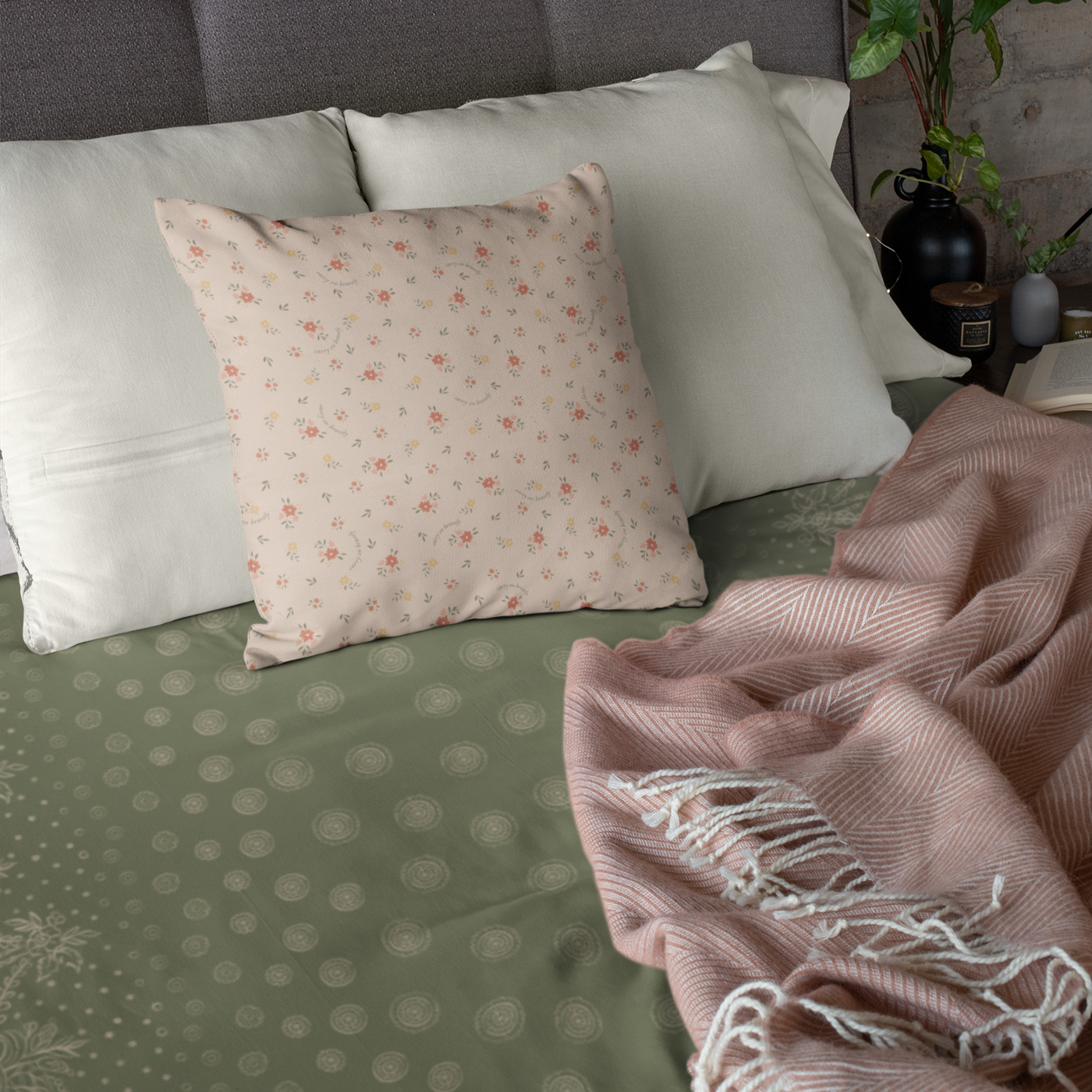 A green and white blanket with a white border, showcasing a gold design of craft symbols by Louis and Zélie. fitted on a bed under the pillows.