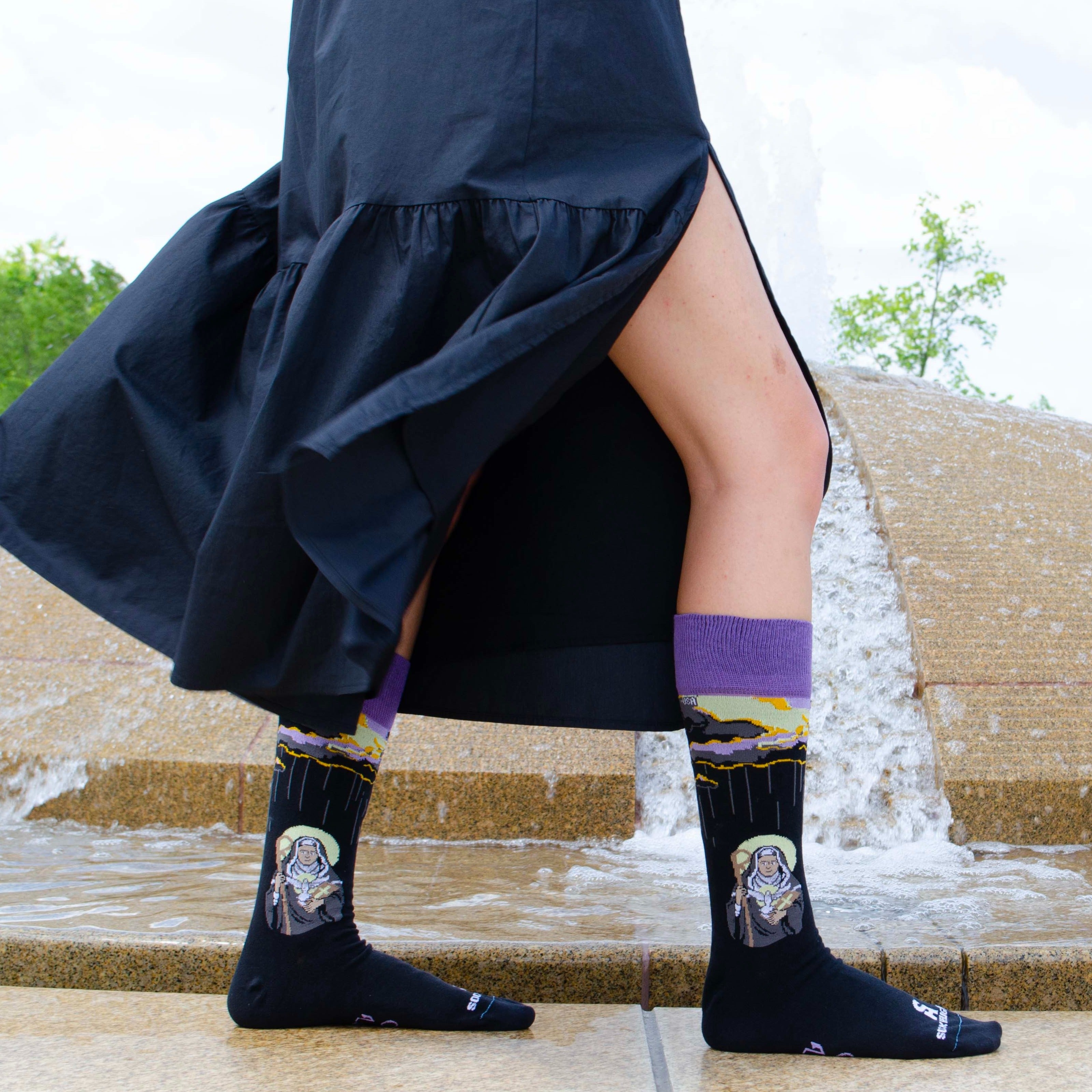 a woman in a skirt and socks standing in front of stairs