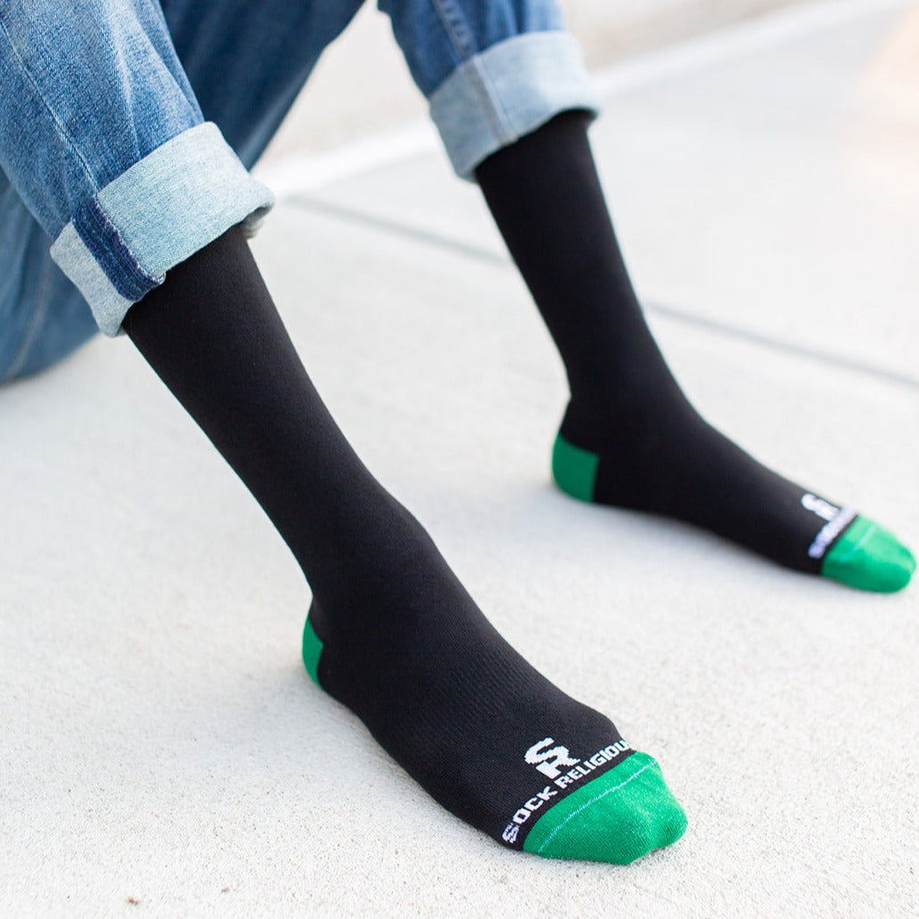 a person wearing black and green