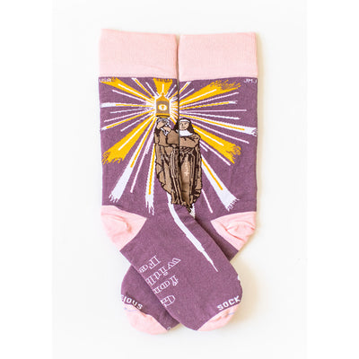 a pair of purple socks with a picture of St. Clare of Assisi