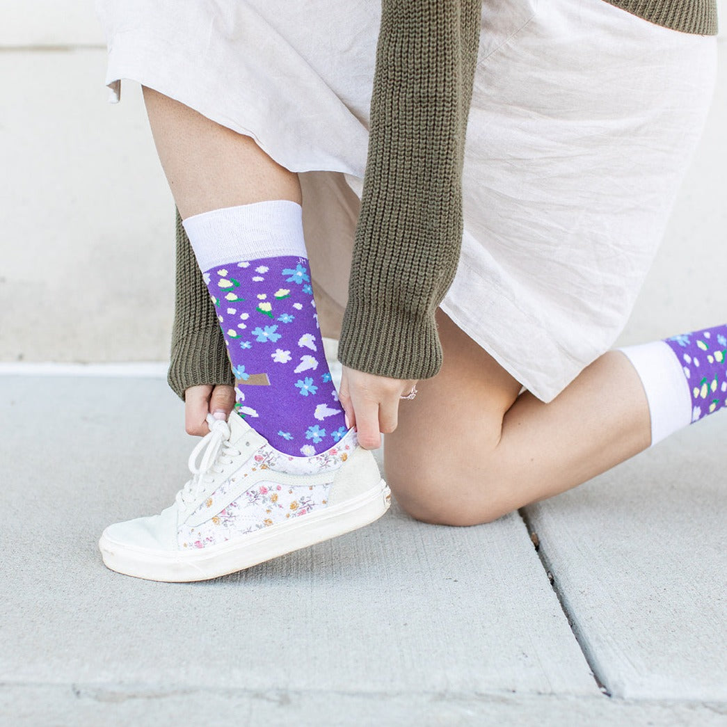a person with purple socks and white shoes