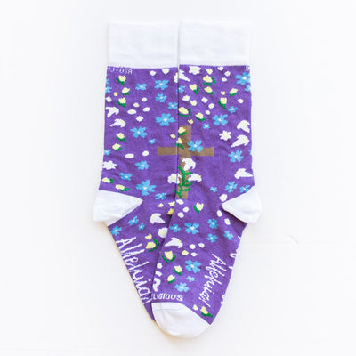 a pair of purple socks with a cross and flowers on it