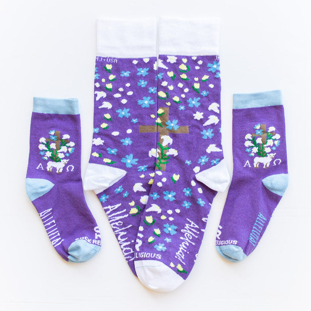 three pairs of purple socks with a cross and flowers on it