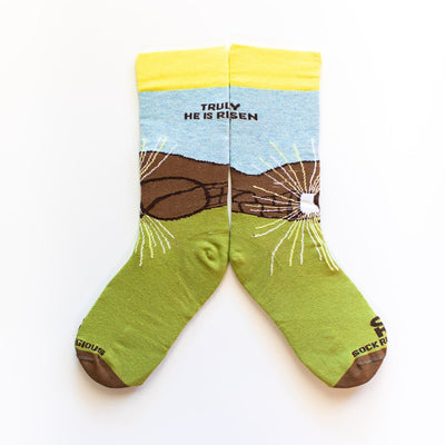 a pair of socks that say, truly he is risen