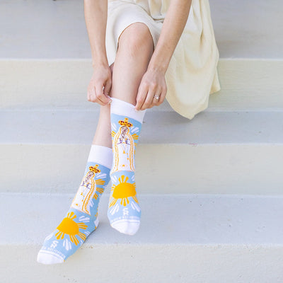 a woman sitting on steps with her legs crossed