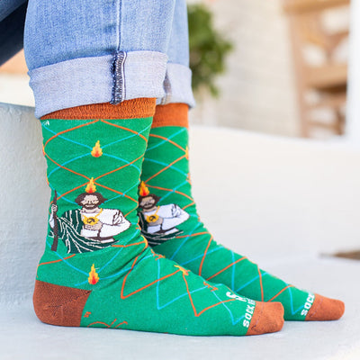 a person wearing a pair of socks with a picture of St. Jude