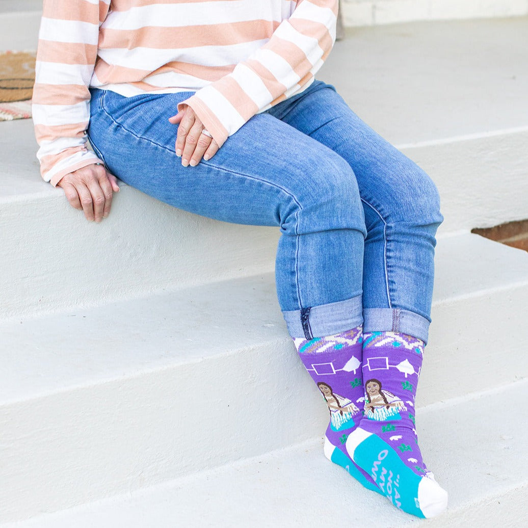 a woman sitting on a step with her legs crossed