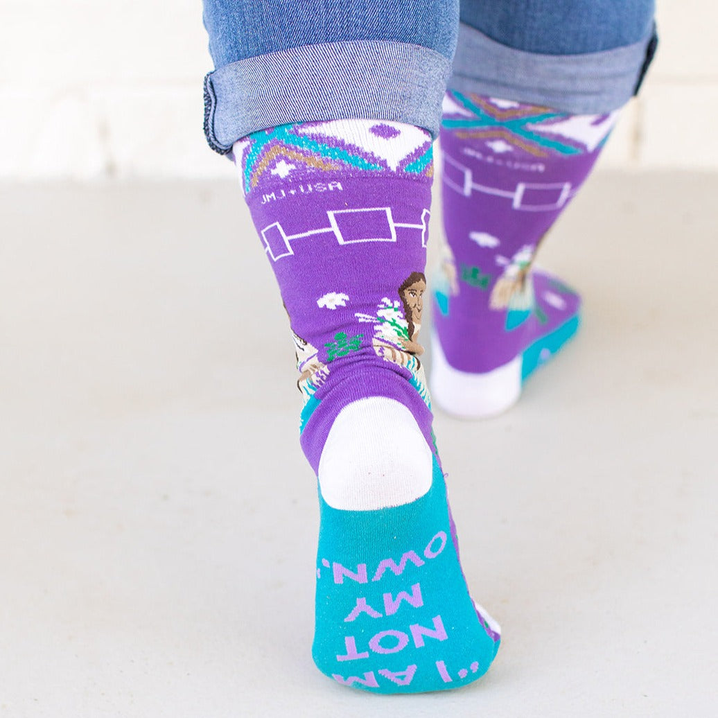 a person wearing a pair of purple socks with a picture of a woman