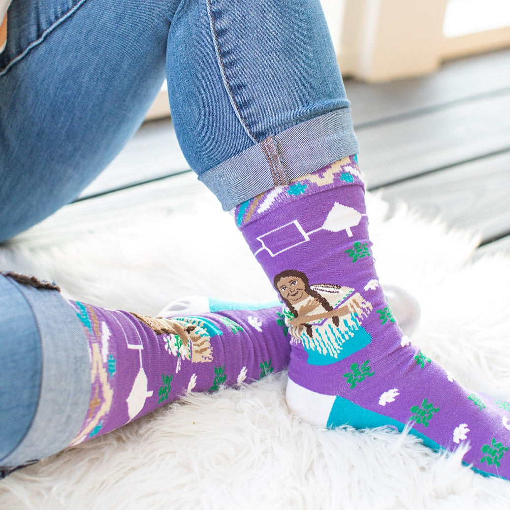 a person wearing purple socks with a picture of a woman on them