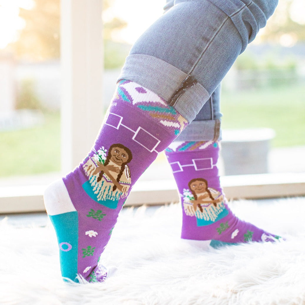 a pair of purple socks with a picture of a woman