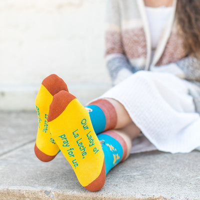 a woman sitting on the ground with her feet up