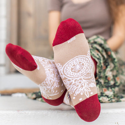 a woman sitting on a step with her feet up