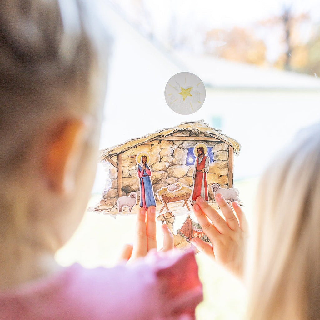 little girls playing with Nativity Cling set on a window