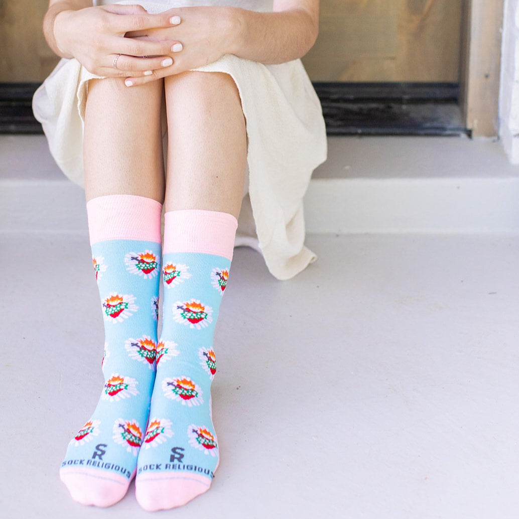 a woman sitting on a step with her legs crossed