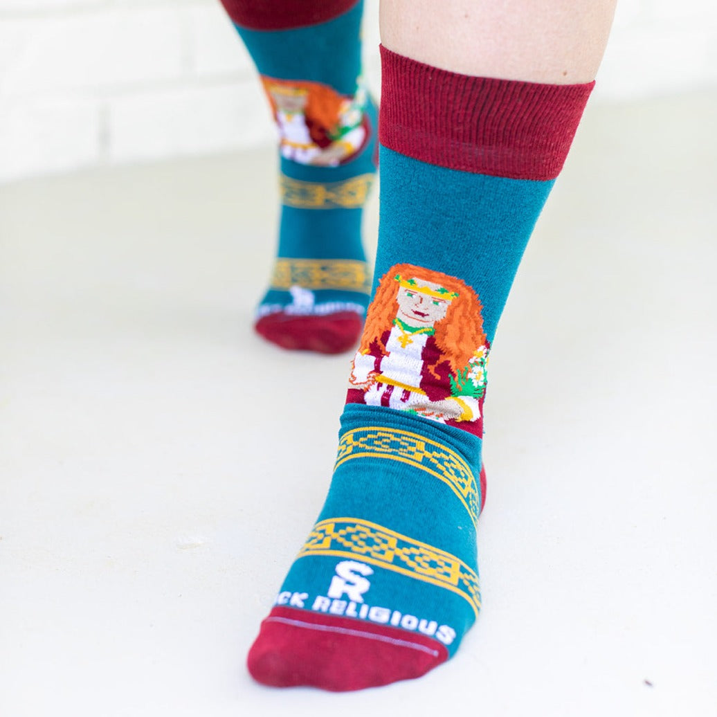 a person wearing a pair of socks with a picture of St. Dymphna