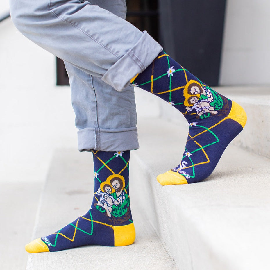 a person standing on a step wearing a pair of St. Joseph socks