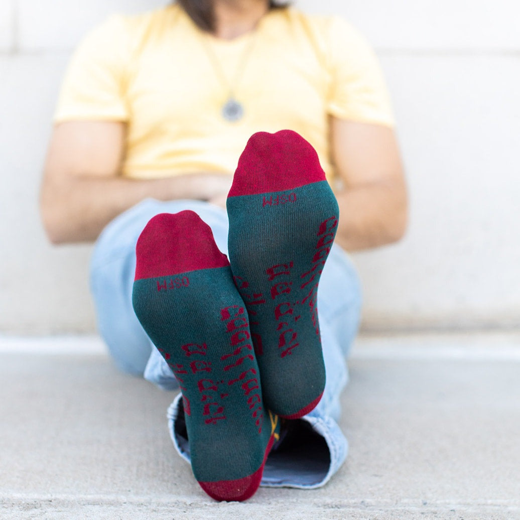 a person sitting on the ground with their feet up