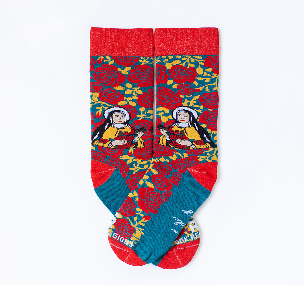 a pair of socks with St. Therese of Lisieux on them, pattern is of red roses