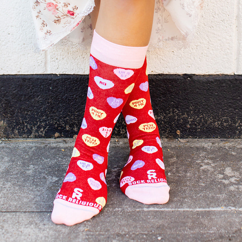 a woman wearing red socks with hearts on them